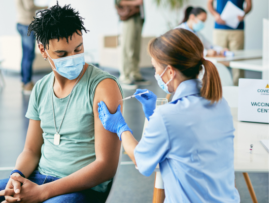 Young man receiving vaccine at a vaccination center